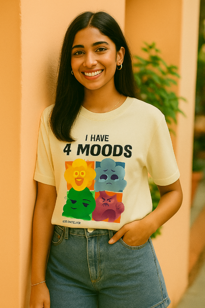 Person wearing a t-shirt with colorful moods design and text 'I have 4 moods' against a peach wall.